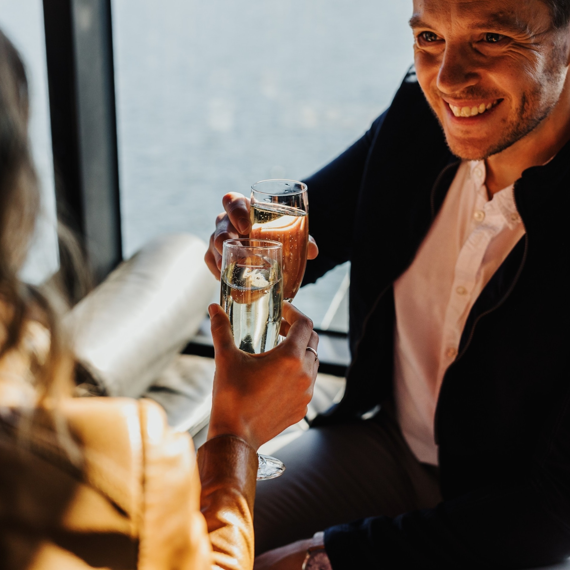 Couple enjoying champagne aboard the MR-1 ferry to MONA in Hobart © Adam Gibson