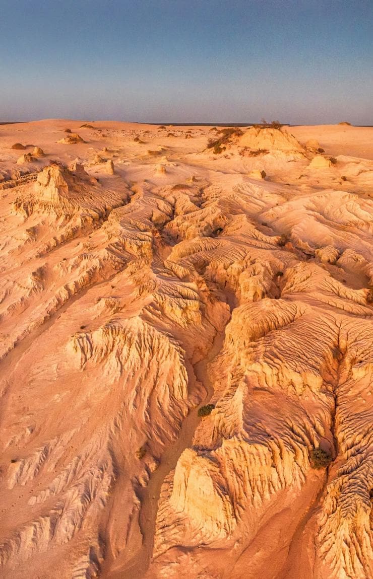 Aerial view over the rugged sand and clay formations of the Walls of China, Mungo National Park, New South Wales © Destination NSW