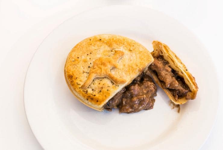 A meat pie cut open on a plate at Mocka's Pies, Port Douglas, Queensland ©  Tourism and Events Queensland/Andrew Watson