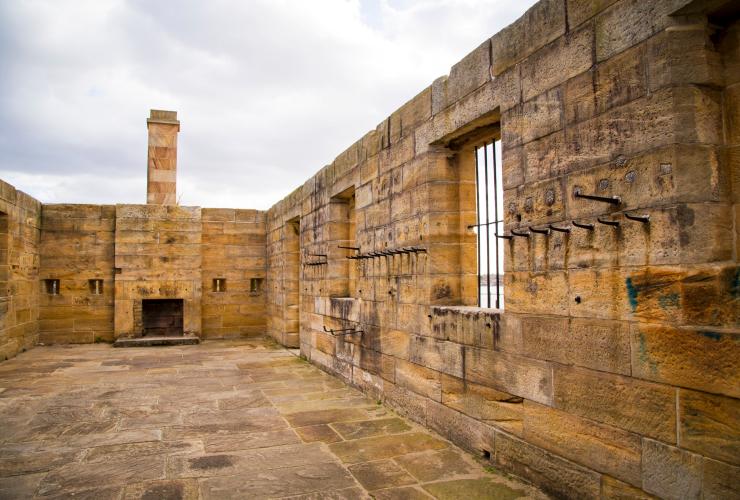 Interior of a historic building with sandstone floors and walls on Cockatoo Island, Sydney, New South Wales © Tourism Australia