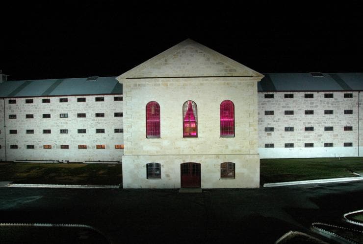 Exterior of Fremantle Prison at night with windows lit up in red, Fremantle, Western Australia © Fremantle Prison