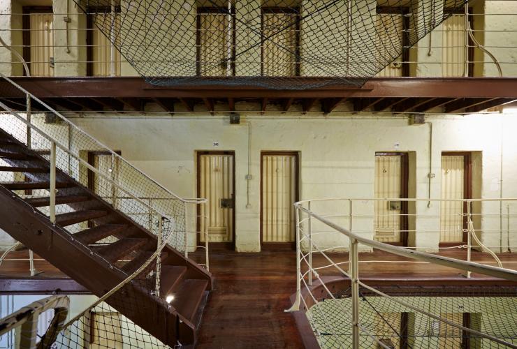 Interior of Fremantle Prison with rows of prison cells and stairs leading between levels in Fremantle, Western Australia © Jessica Wyld