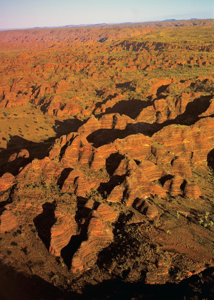 Aerial view over the rugged orange rock domes of the Bungle Bungle Range, Purnululu National Park, Western Australia © Tourism Australia