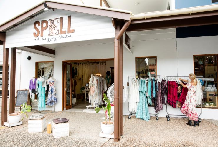 Woman arranging clothes for display at the Spell & The Gypsy Collective, Byron Bay, New South Wales © Destination NSW