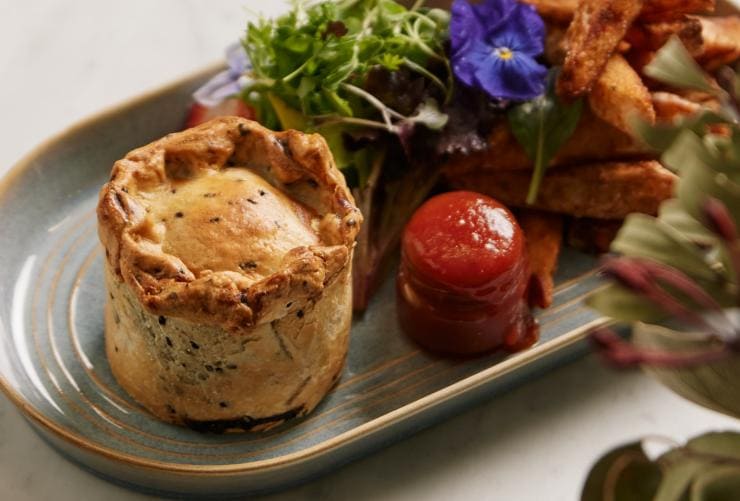 A small meat pie plated with chips and salad at Beerenberg Farm, Adelaide Hills, South Australia © Beerenberg Farm