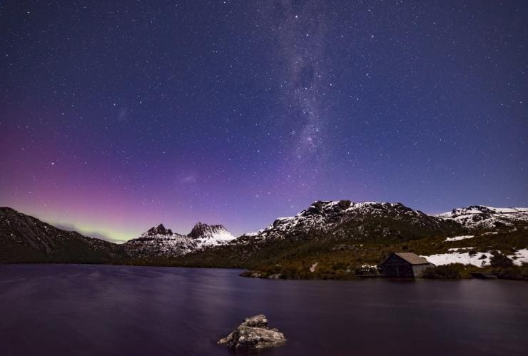 View of the Aurora Australis glowing in the night sky over snow-capped Cradle Mountain in Cradle Mountain-Lake St Clair National Park, Tasmania © Pierre Destribats