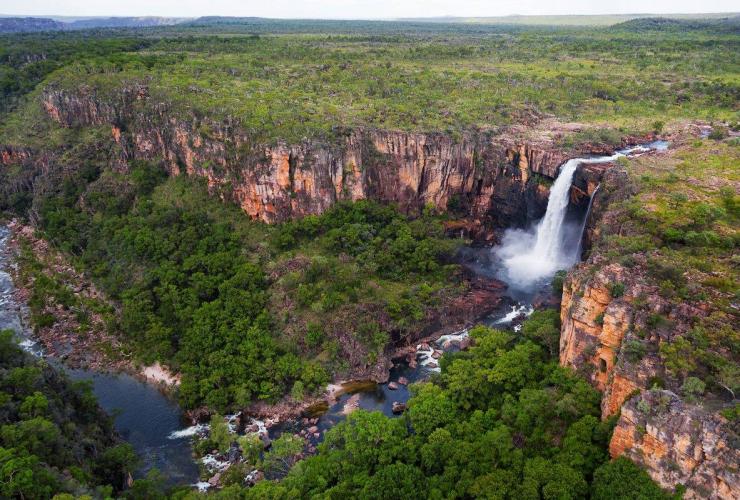 Aerial view over Jim Jim Falls and the expanse of red rock and greenery throughout Kakadu National Park, Northern Territory © Kieran Stone