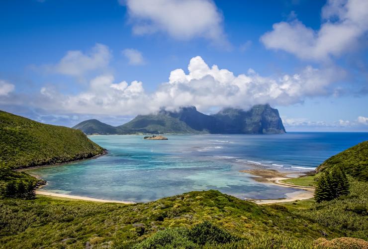 View over the green peaks, white sand and blue water of Lord Howe Island from North Bay walk, New South Wales © Luke Hanson