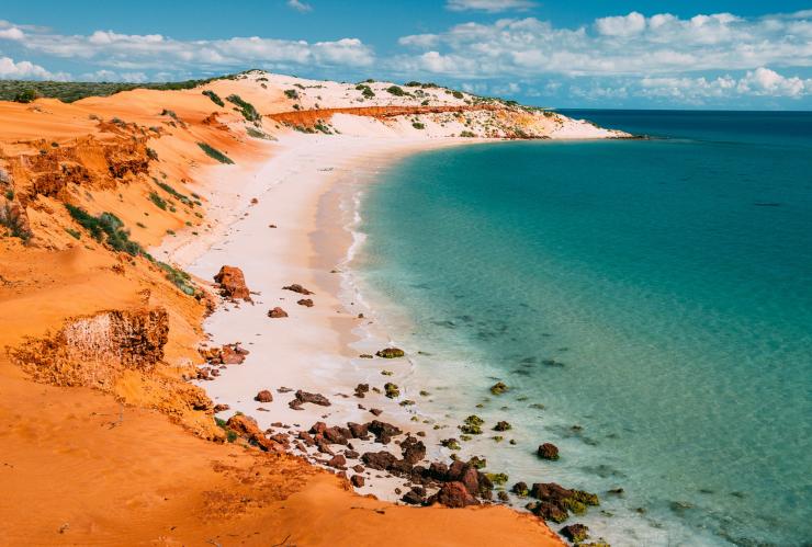 Aerial view over a red sand formation leading to white shores and blue water in Francois Peron National Park, Shark Bay World Heritage Area, Western Australia © Tourism Western Australia