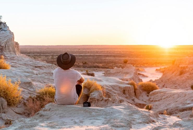 Man watching the sunset at the Walls of China sand and clay formations in Mungo National Park, New South Wales © Tyson Mayr