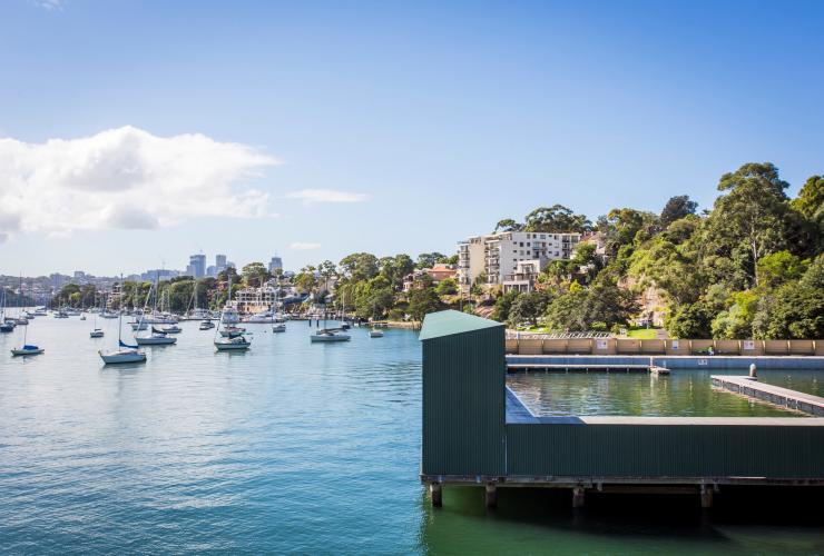 The sheltered Dawn Fraser Baths on stilts over the ocean with sailboats in the background in Balmain, Sydney, New South Wales © Destination NSW