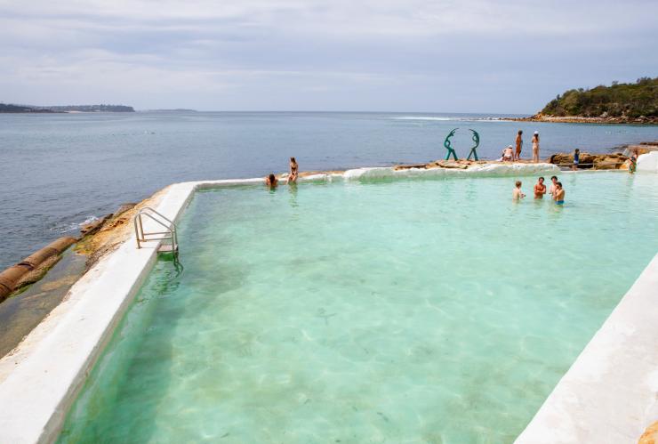 People swimming in the clear blue water of Fairy Bower Ocean Pool with the ocean behind them in Manly, New South Wales © Destination NSW