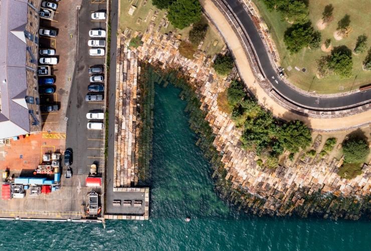 Aerial view over the turquoise water and surrounding greenery of Marrinawi Cove, Barangaroo Reserve, Sydney, New South Wales © NSW Government